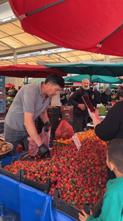 Vendor bags fresh strawberries at Alanya market