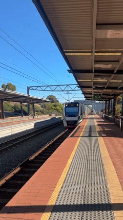 Train 4111 arrives at Wellard station on sunny morning