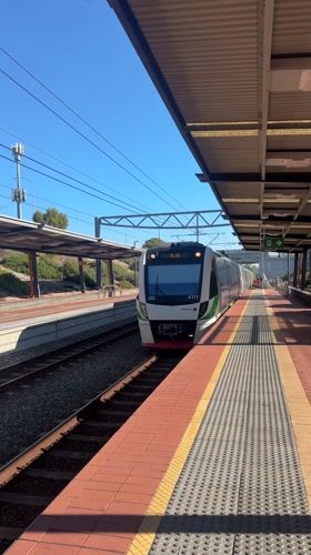 Train 4111 arrives at Wellard station on sunny morning