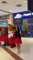 Woman poses with capybara mascots in Peru shopping mall