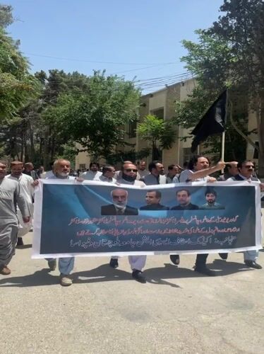 Men demonstrate with banners in Quetta, Pakistan