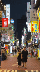 Couple walks hand-in-hand on busy Seoul street
