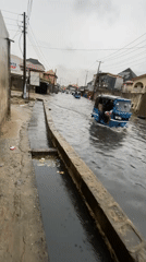 Heavy flooding hits residential area, vehicles and pedestrians navigate waters