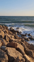 Golden hour on Quarteira's rocky beach shoreline