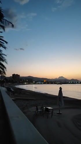 Dusk settles over El Campello's palm-lined beach