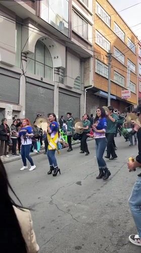 Street parade with dancers and marching band in La Paz