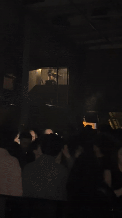 DJ performs in Paris nightclub as delivery activity continues