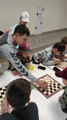 Kids' checkers tournament at a sports center in Noviy, Russia
