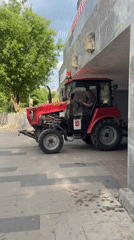 Tractor drives on sidewalk in Khimki, Russia