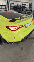 Custom lime-green BMW M4 showcased in workshop setting