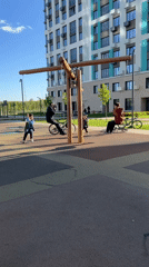 Children play at playground near bicycle mural in Ufa