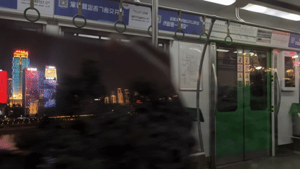 Subway passenger captures nighttime cityscape views in Yuzhong District