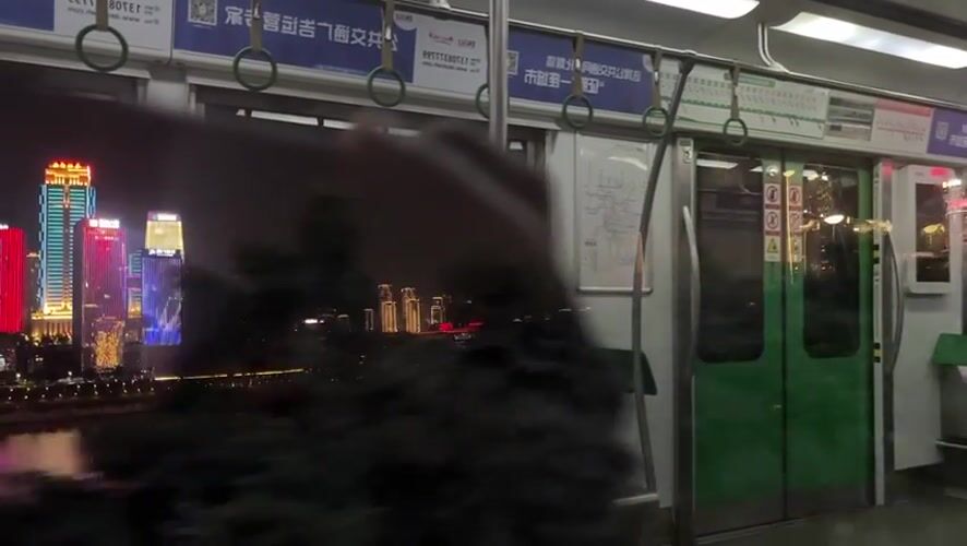 Subway passenger captures nighttime cityscape views in Yuzhong District