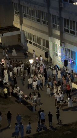 Youth dance gathering with DJ outside Kragujevac school building