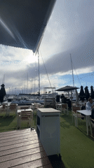 DJ performs at empty marina-side restaurant patio in Valencia