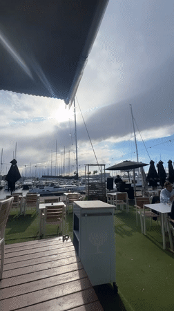 DJ performs at empty marina-side restaurant patio in Valencia
