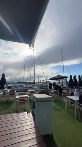 DJ performs at empty marina-side restaurant patio in Valencia