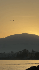 Paragliding over Estepona at sunset, mountains and coast below