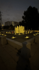 Color-lit fountain display in a Moscow public square at night