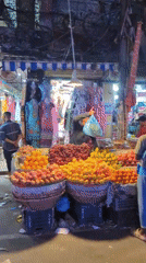 Dhaka night market street scene, shops and traffic under purple lights