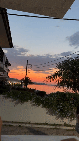 Sunset views and utility work along the Greek coast at dusk
