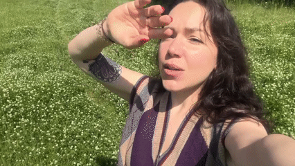 Woman films herself in flower field near Tvarditsa, Bulgaria