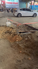 Street construction underway in Mũi Né with excavator, safety barriers