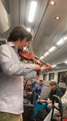 Musicians perform for passengers on coastal train route