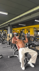 Man performs dumbbell workout at Paris gym
