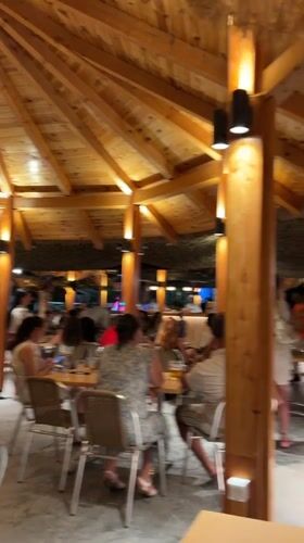 Live music and costumed performers at a Boreti beach venue