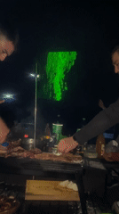 Late-night barbecue gathering with laser fishing in Iquique, Chile