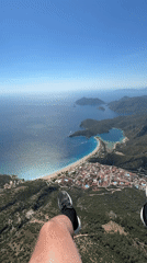 Paraglider soars over Fethiye's coastal landscape in Turkey