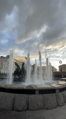 Tourists capture Moscow landmarks during afternoon fountain display