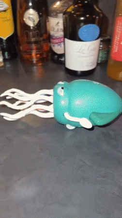 Toy octopus robot crawls across cluttered Osaka kitchen counter
