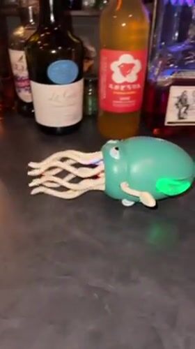 Toy octopus robot crawls across cluttered Osaka kitchen counter