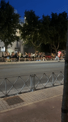 Evening joggers traverse Córdoba sidewalk in group run