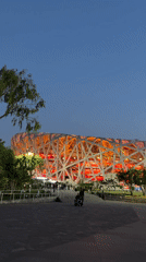Evening visitors explore illuminated Beijing Olympic Park facilities