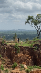 Two people observed on plateau overlooking hills in Amaseri