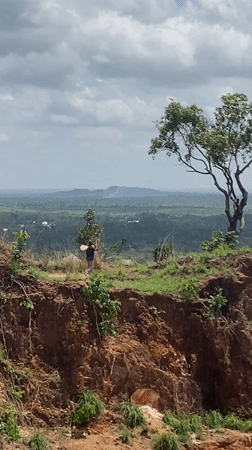 Two people observed on plateau overlooking hills in Amaseri
