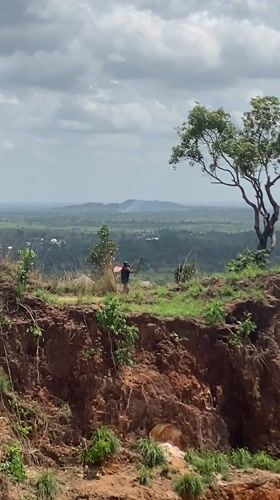 Two people observed on plateau overlooking hills in Amaseri