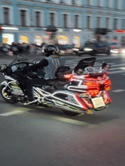Dusk street scenes in Saint Petersburg: fashion poses and lit-up motorcycle