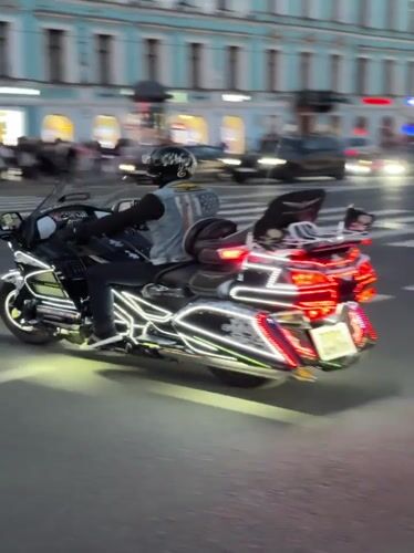 Dusk street scenes in Saint Petersburg: fashion poses and lit-up motorcycle
