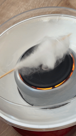 Girl watches cotton candy machine operation in Krasnoyarsk