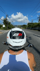 Motorcyclist with anime stickers rides sunny Kathu road