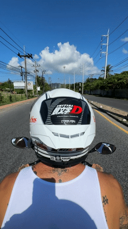 Motorcyclist with anime stickers rides sunny Kathu road