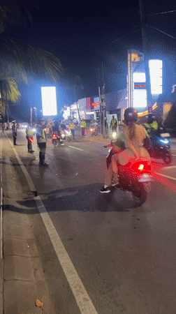 North Kuta nightlife: traffic, street scenes, and stone guardians