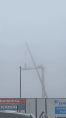Crane operator works through heavy fog in Burgas