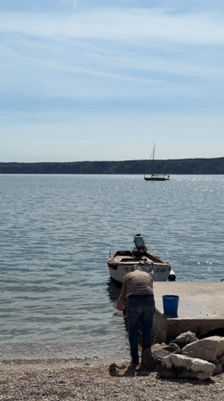 Family enjoys spring afternoon at Croatian coastal playground and pier