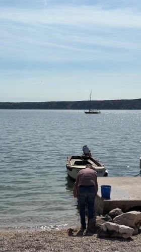 Family enjoys spring afternoon at Croatian coastal playground and pier