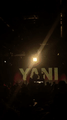 Crowded nightclub event under colorful stage lighting at YANI
